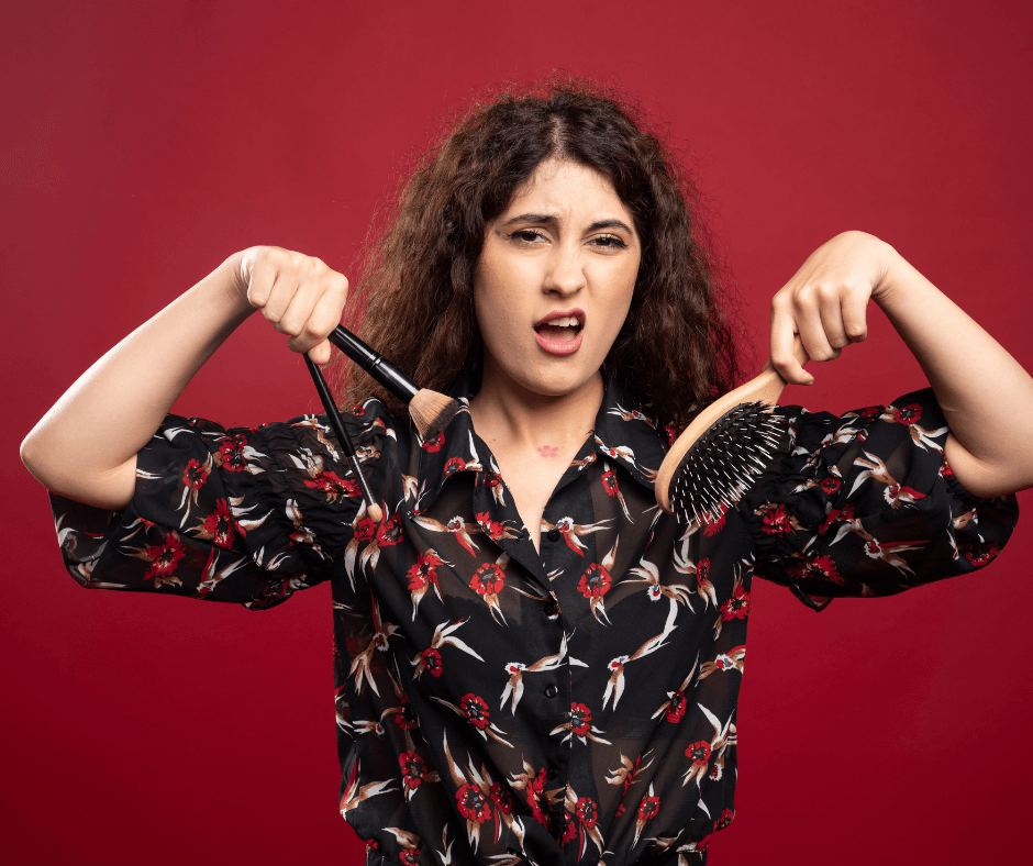 woman-holding-makeup-brushes-comb