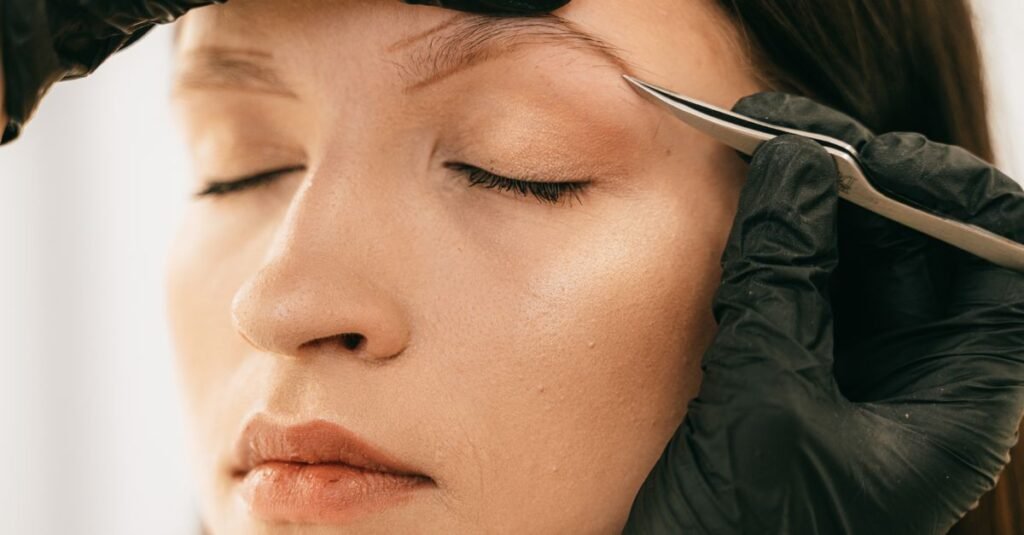 Close-up of eyebrow tweezing