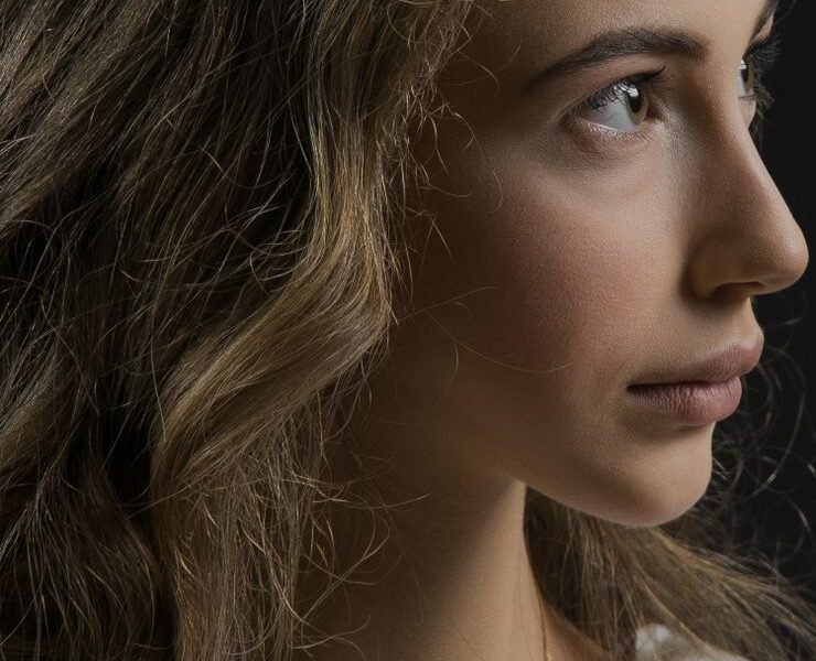 Close-up of a woman with warm, glowing, sun-kissed bronzed skin