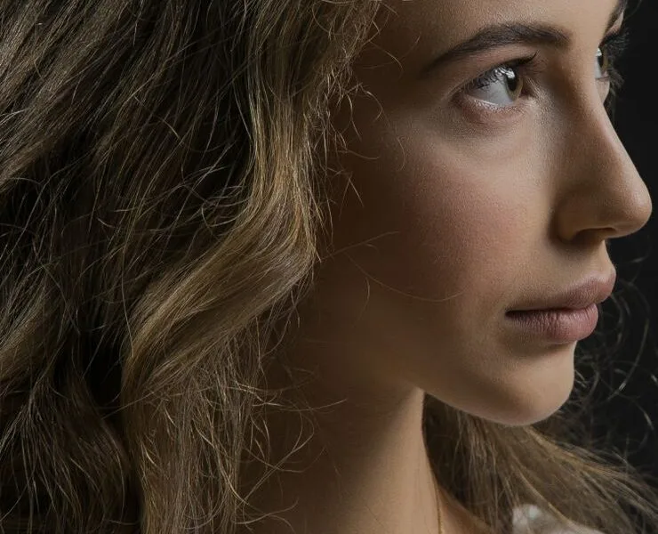 Close-up of a woman with warm, glowing, sun-kissed bronzed skin