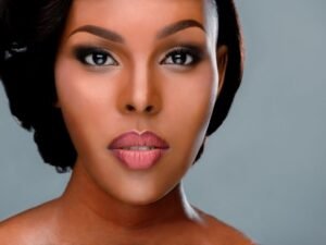 Close-up of a woman with glowing, highlighted skin and radiant makeup