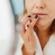 Woman applying a nourishing lip mask treatment to her lips