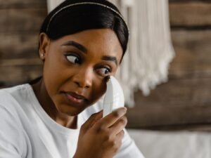 Woman using an at-home facial beauty device