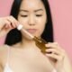 Woman using a retinol serum dropper