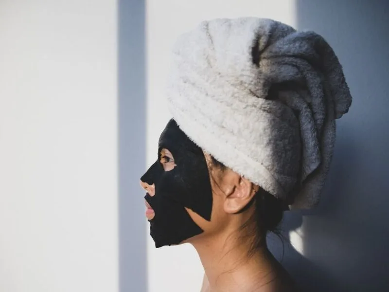 Face sheet mask on model, glowing skincare treatment