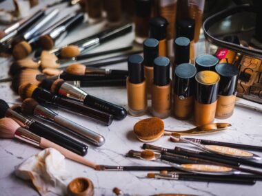 A collection of foundation makeup bottles and brushes