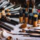 A collection of foundation makeup bottles and brushes