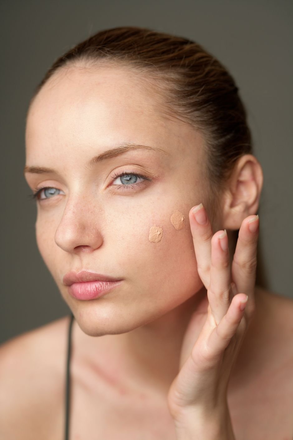 Two foundation shades swatched and blended on a cheek to find the match