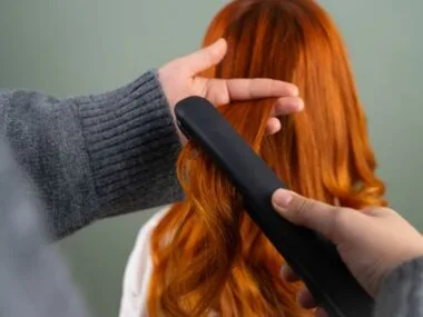 Hair straightener creating sleek smooth styled hair