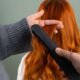 Hair straightener creating sleek smooth styled hair