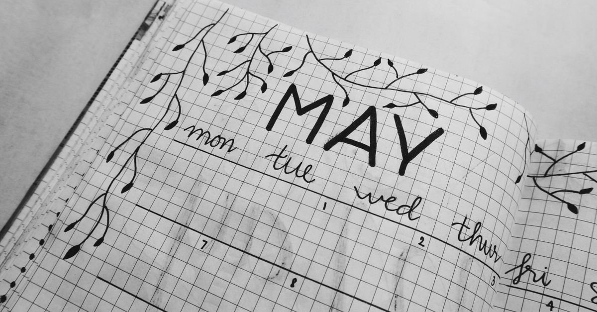 A hand-drawn monthly calendar in a journal