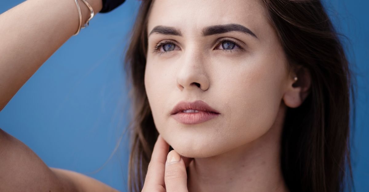 A portrait of a woman with clear, natural skin