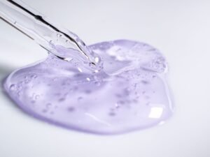 A dropper resting beside a blob of clear gel essence