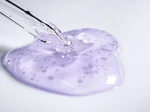A dropper resting beside a blob of clear gel essence