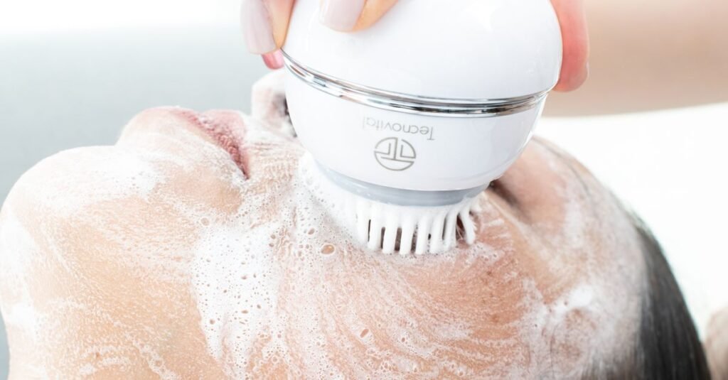 Scalp massage brush working through lather