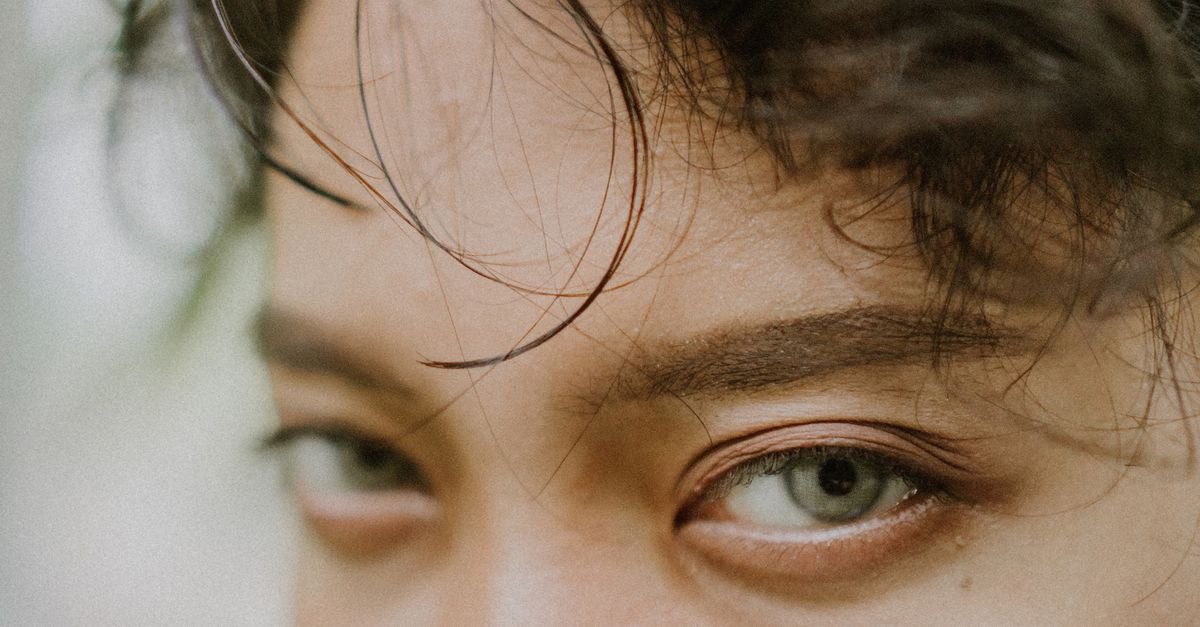 Close-up of a forehead and eyes with damp hair