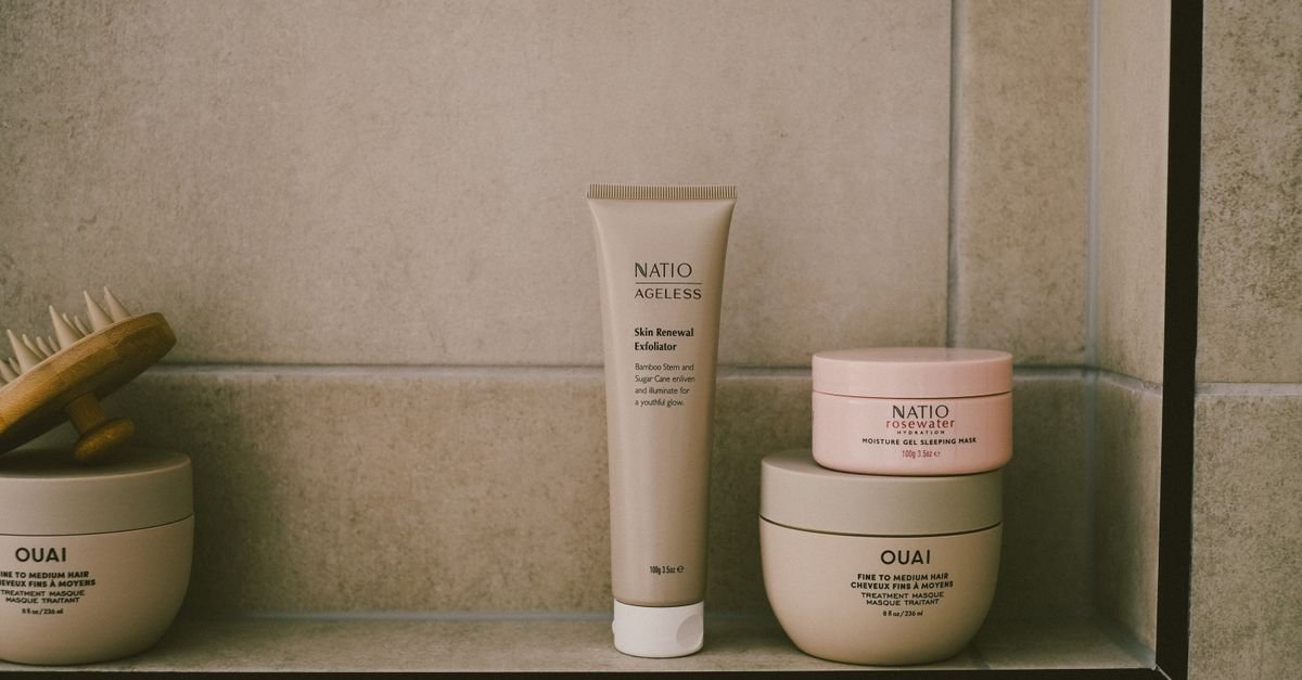 Skincare products arranged on a bathroom shelf