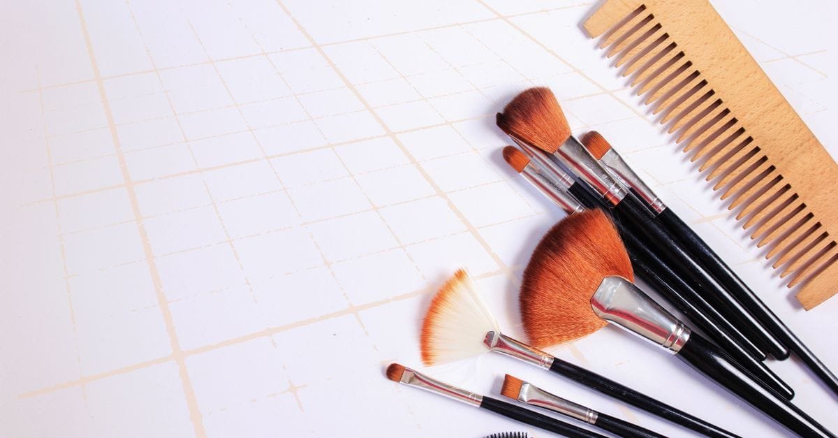 Wooden combs and brushes in a neutral flat lay