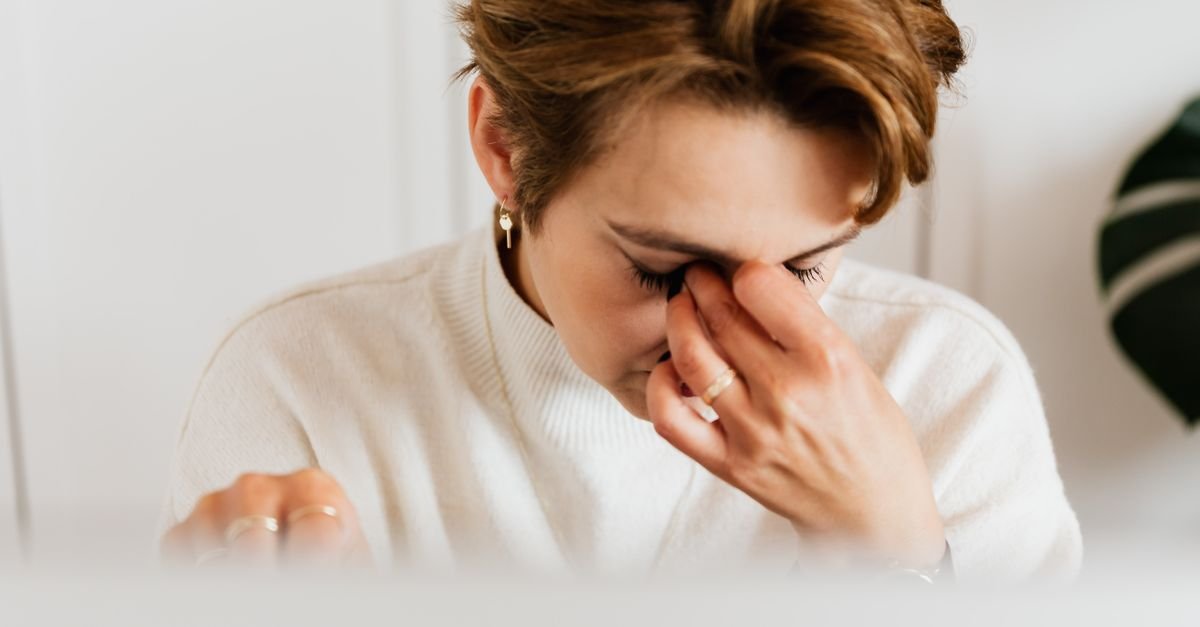 A woman rubbing her tired eyes