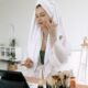 A woman in a towel doing her evening skincare routine