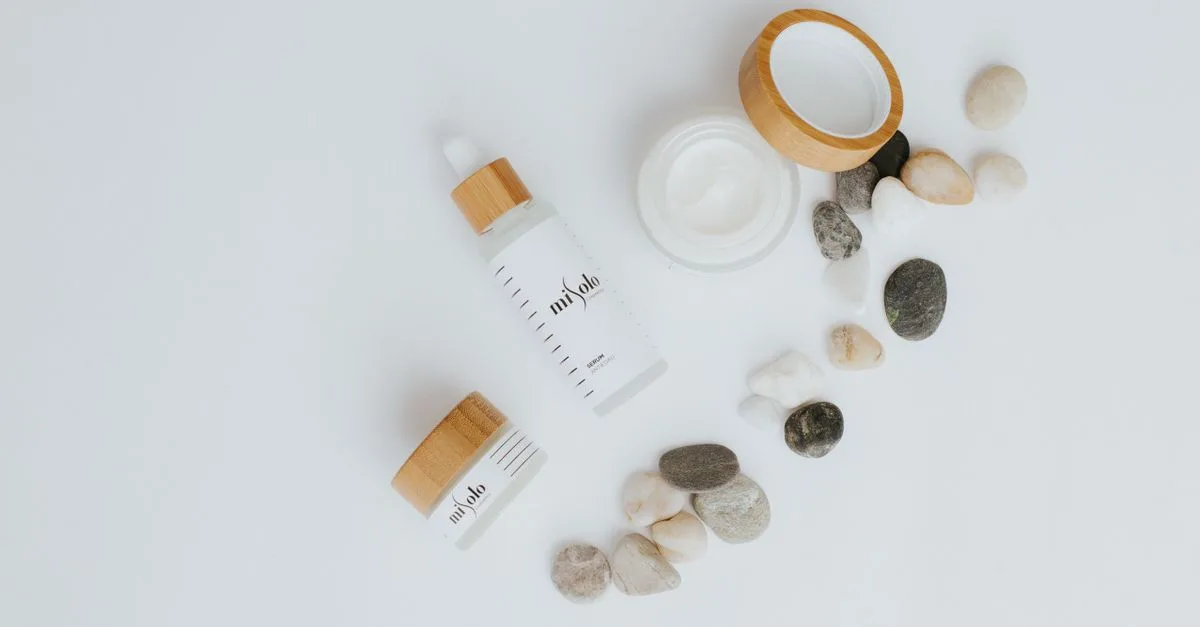 A minimal flat lay of skincare bottles and stones