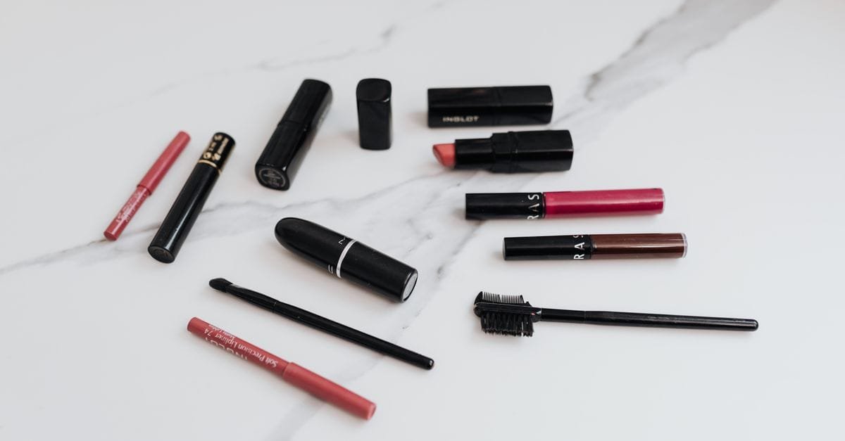 Lipsticks and liners scattered on marble