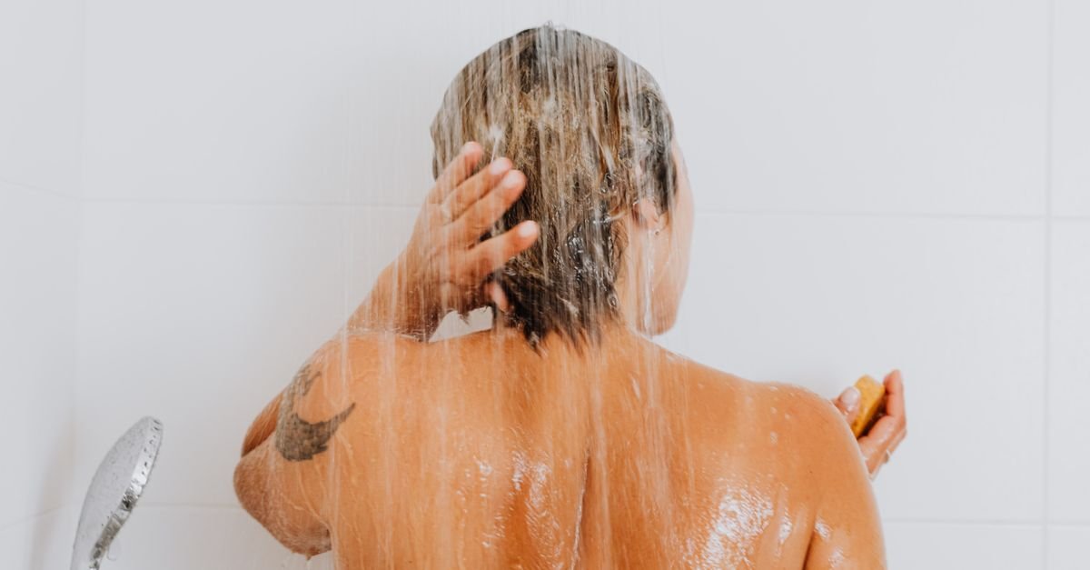 A woman rinsing her hair in the shower