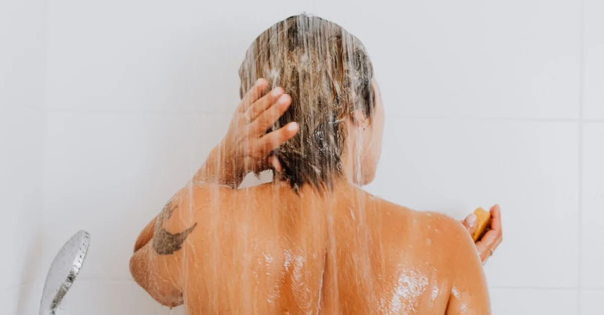 A woman rinsing her hair in the shower