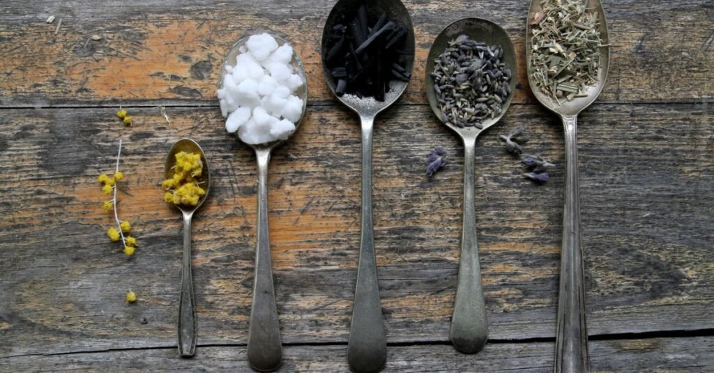 Spoons of botanical powders on weathered wood