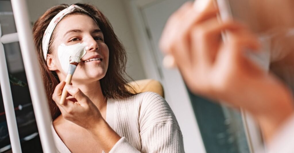 Smiling woman applying a face mask with a headband