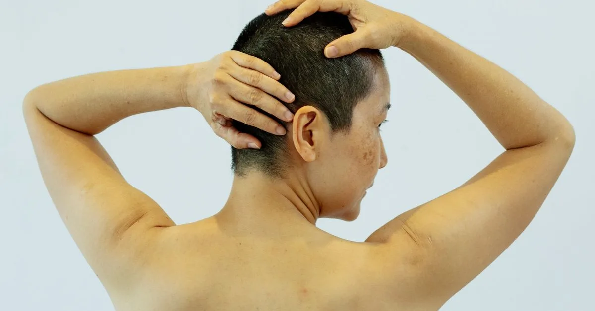 A woman&rsquo;s shoulder and upper back