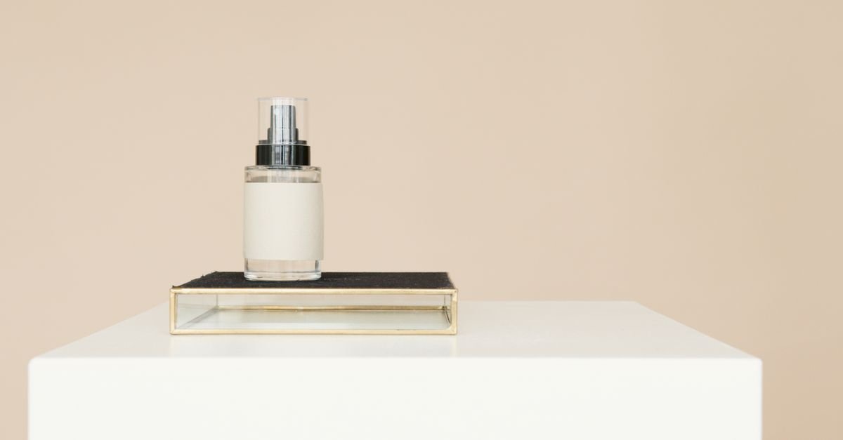 A minimal white spray bottle on a small stand