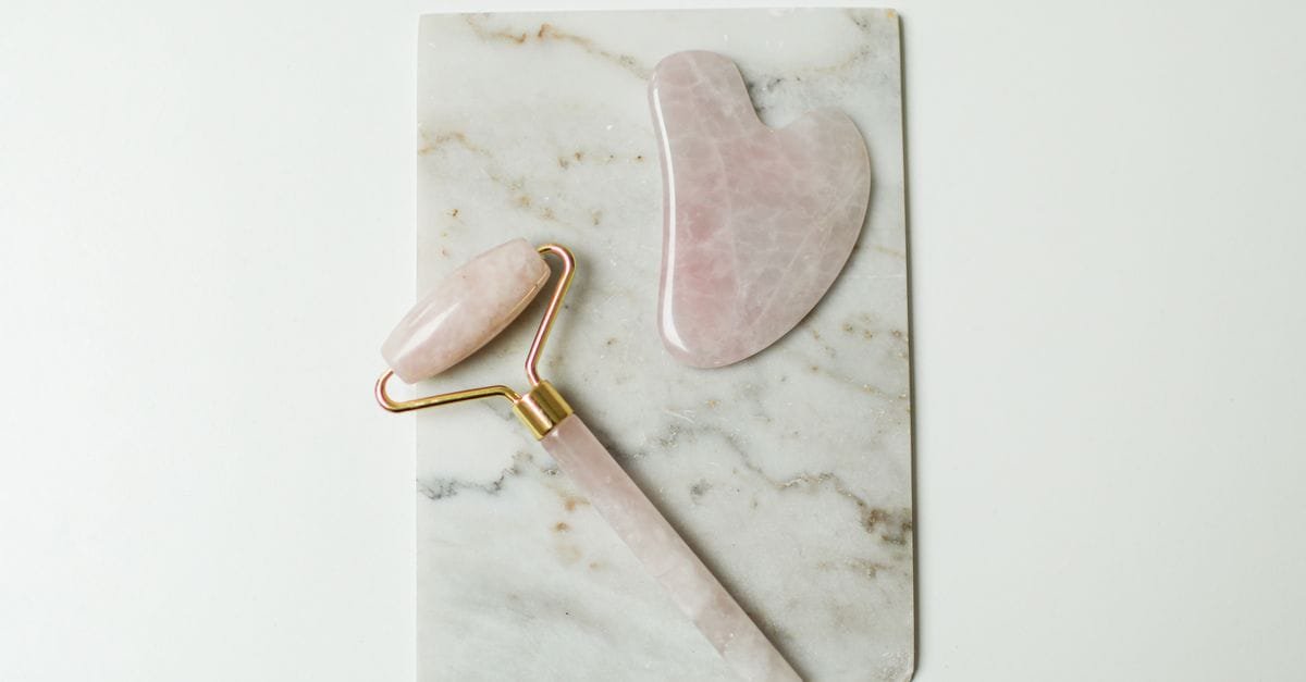A rose quartz gua sha set on marble