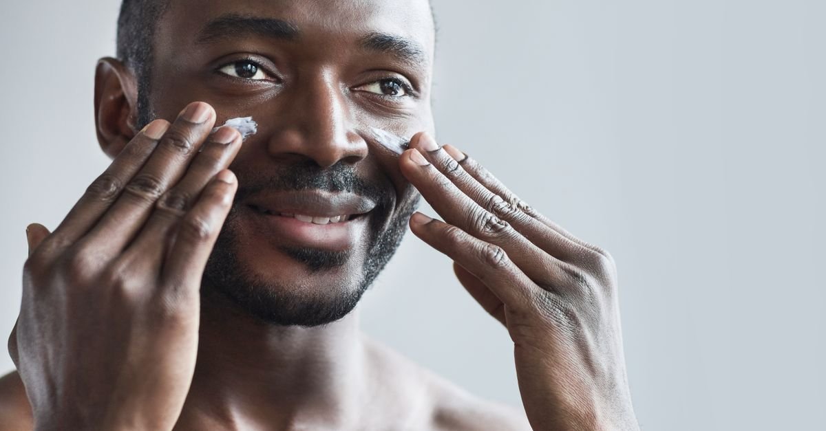 A man applying moisturizer cream to his face