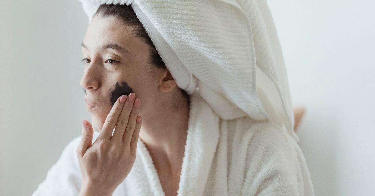 Woman applying a treatment product to her face