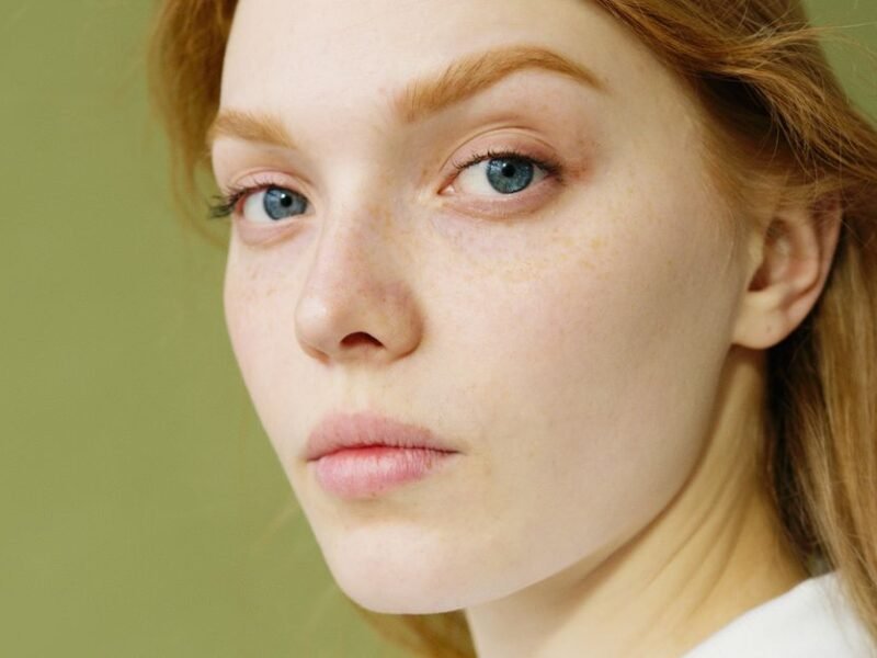 A woman with bare, natural skin looking at the camera