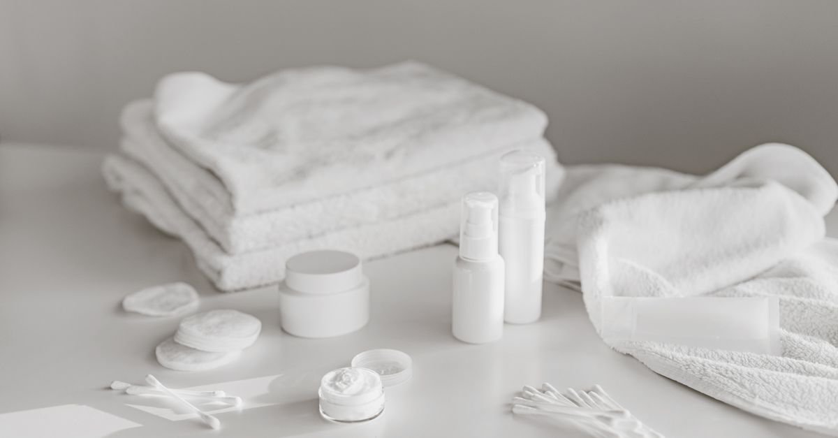 Simple white skincare products and towels