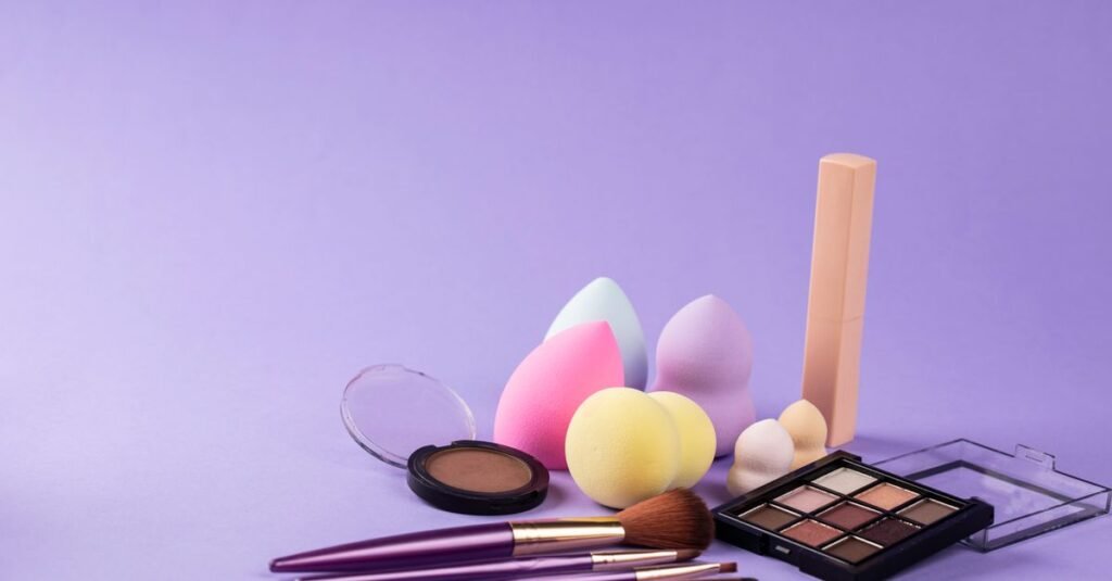 Makeup sponges and brushes on a lilac background