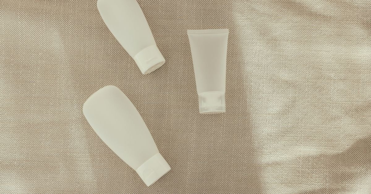 Unbranded skincare tubes on a neutral cloth