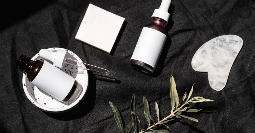 Dark flat lay of serum bottles and a stone dish