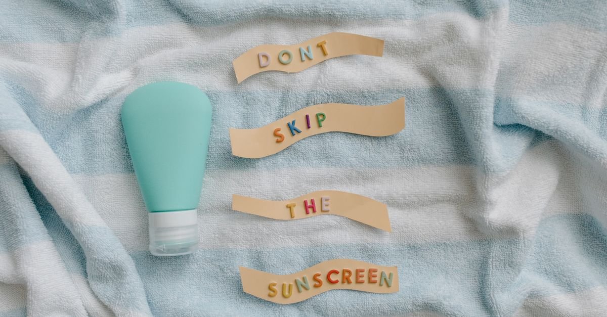Letters spelling a sunscreen reminder on a beach towel