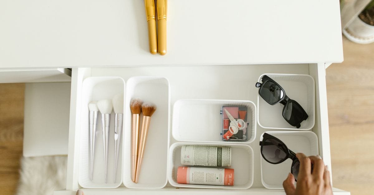 An organized makeup drawer with brushes and products