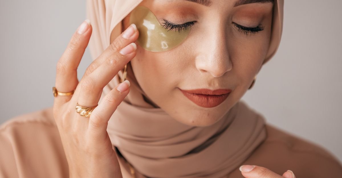 A woman wearing gold under-eye patches