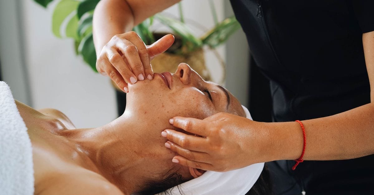 A woman receiving a professional facial massage