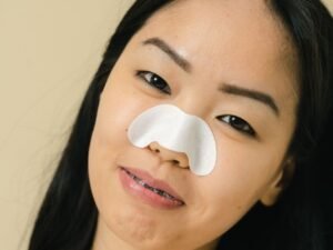 Using a pore strip to remove blackheads on the nose