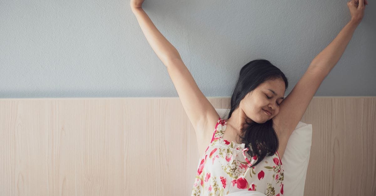 A woman stretching awake in the morning