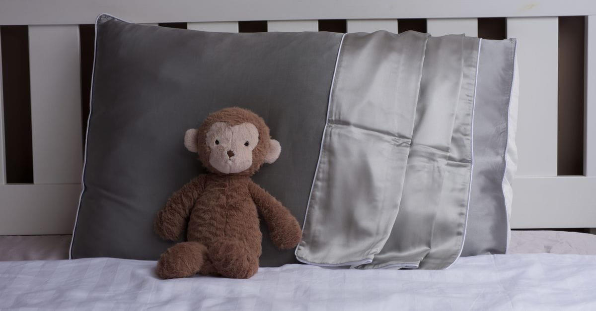 Silk pillowcases on a made bed