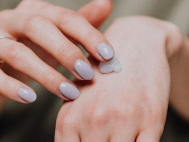Hands with natural nails and a dab of cream