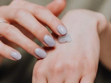 Hands with natural nails and a dab of cream