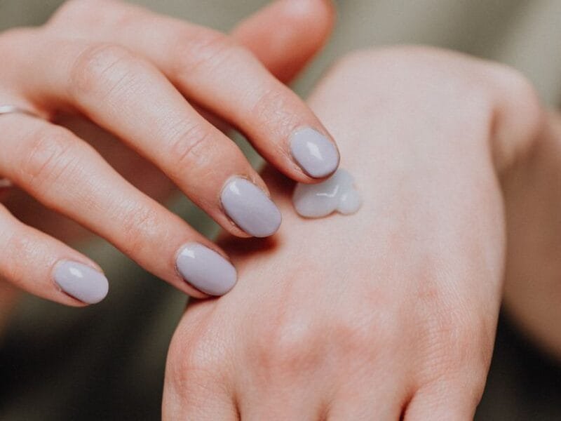 Hands with natural nails and a dab of cream